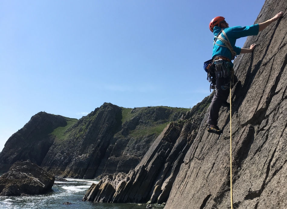 Henry climbs Becks Direct on Becks Slab at Penally